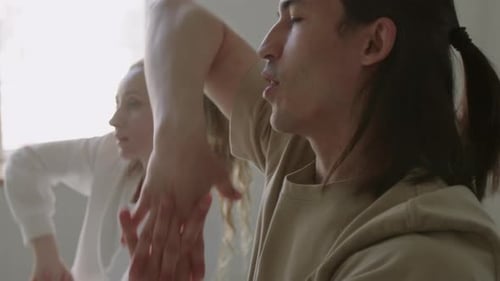 Couple of Dancers Warming Up Wrists in Studio