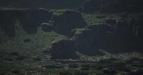 Vast Rocky Landscape with Lush Greenery During Daylight in an Isolated Area