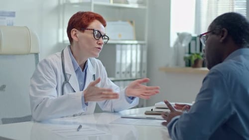 Female Physician Consulting Patient during Medical Appointment in Clinic