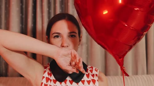 Woman with Heart Balloon Posing for Camera