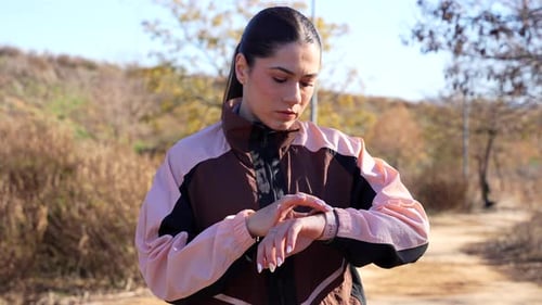 Woman Checking Smart Watch During Outdoor Workout