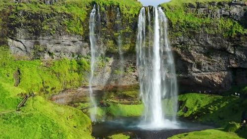 Picturesque Landscape Of Seljalandsfoss Waterfall Flowing In The Cliff In Summer. - aerial approach