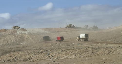 Trucks and Construction Vehicles in Desert Landfill