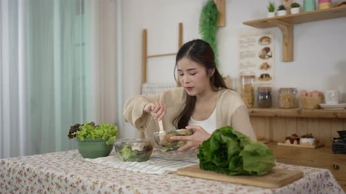 Woman Enjoys Fresh Salad in Bright Kitchen