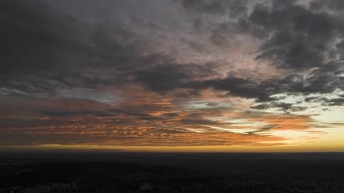 Aerial drone hyperlapse timelapse of moving sunset sky with clouds