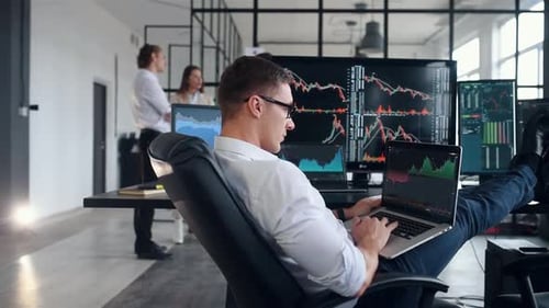 Team of stockbrokers works together in modern office at daytime
