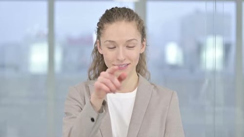 Portrait of Beautiful Young Businesswoman Pointing Finger and Inviting