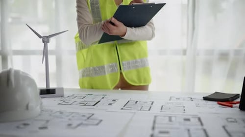 Close up of hands working on drawings architectural and engineering
