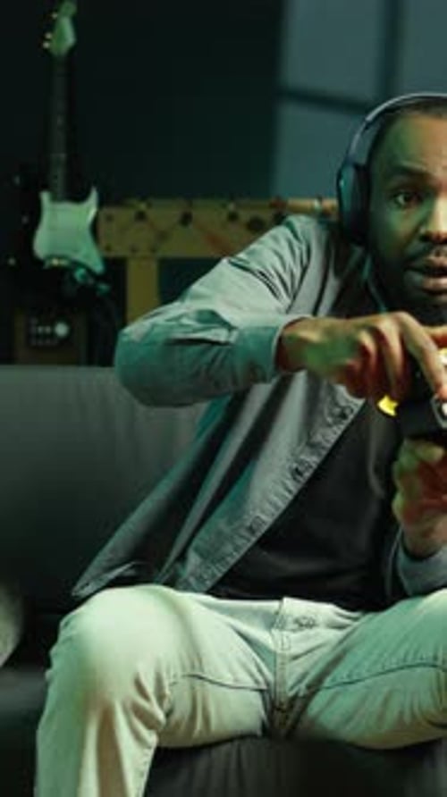 Man Relaxing at Home While Playing Video Games