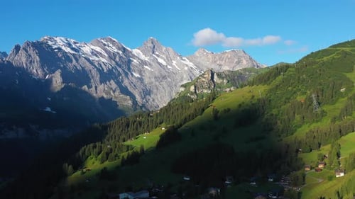 Wide rotating drone shot of the Swss Alps and Murren, in the Bernese Highlands of Switzerland.