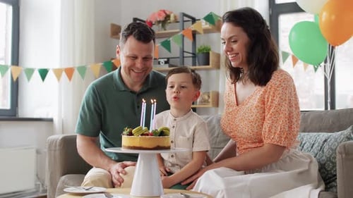 Happy Family Celebrating Boy's Birthday with Cake