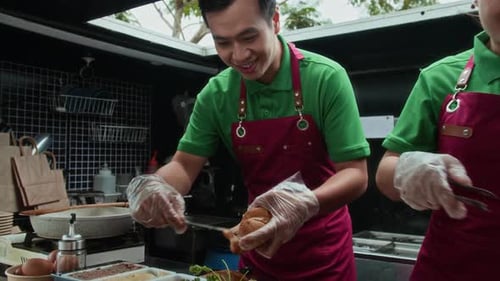 Food Truck Workers Preparing Tasty Sandwiches Together