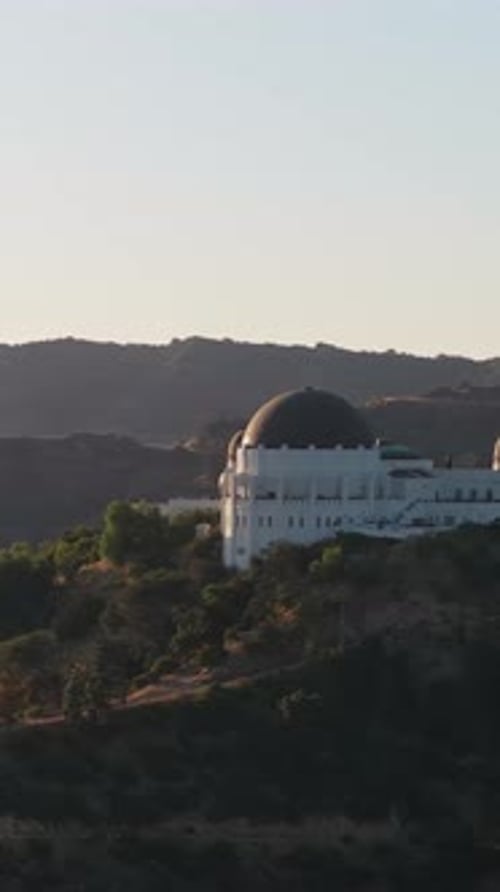 Griffith Observatory Orbiting with Hollywood Sign and Los Angeles in Background Cinematic Shot of