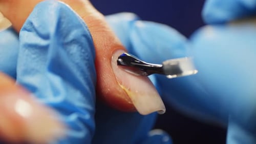 Closeup of Applying Gel Base with a Brush to the Nail Plate