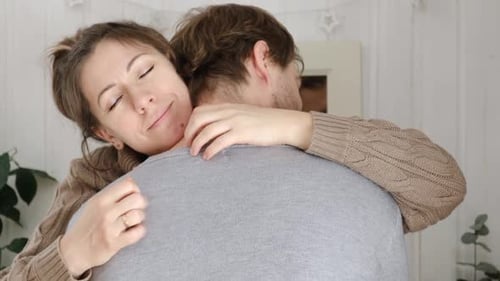 Woman Embracing Man in Cozy Home Setting