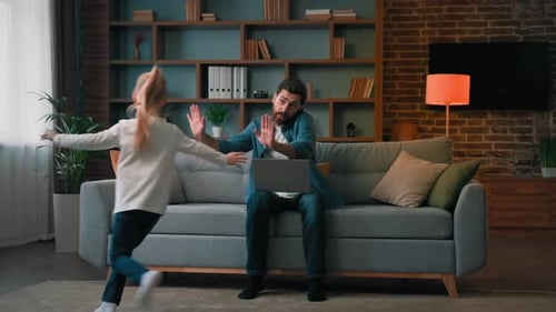 Busy Father Working From Home, Distracted by Child