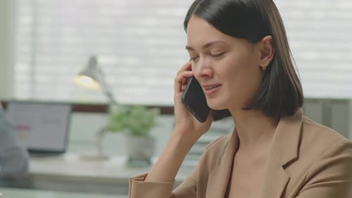 Businesswoman Calling on Phone in Office