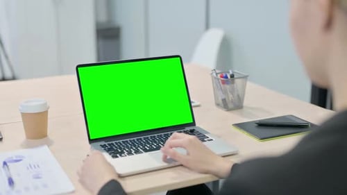 Businesswoman Using Laptop with Green Screen