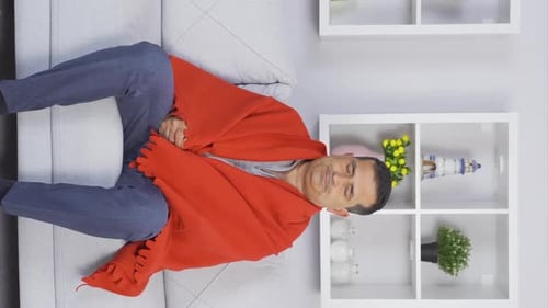 Vertical video of Depressed old man on the sofa.