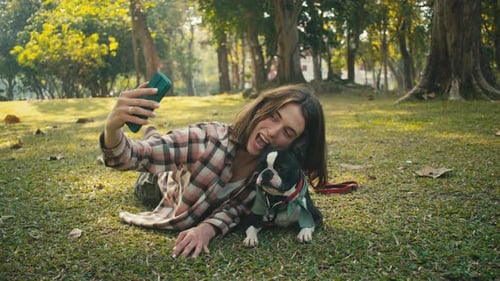 Woman Takes Selfie with Dog in Green Park