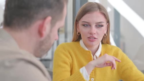 Close up of Young Female in Talk with Middle Aged Man