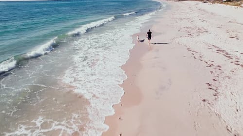 Early Morning Jog Along the Sandy Shores of a Scenic Beach
