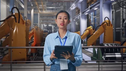 Woman Using Tablet in Futuristic Factory