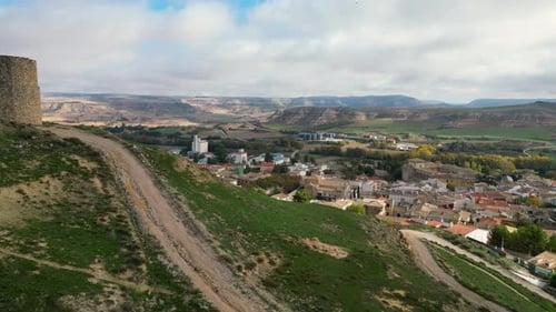 flight on a hill with remains of a medieval fortress discovering a town with an ancient palace and c