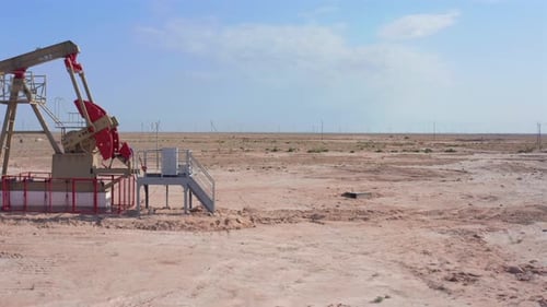 Drone Flyby of Oil Pumpjack Revealing Desert Panorama