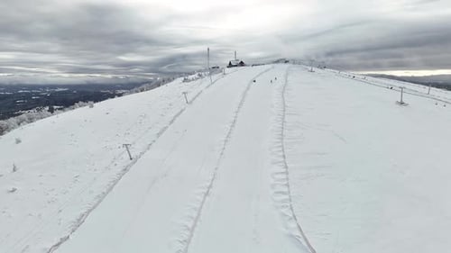 Aerial View of Wide Snowy Ski Run on Mountain Slope at Day Winter Sport Infrastructure and Tracks at