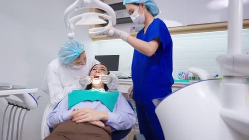 Caucasian dentist examine tooth for young girl at dental health clinic.