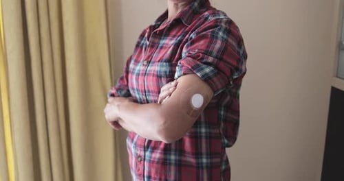 Woman with Continuous Glucose Monitor on Arm