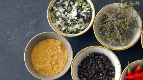 Variety of dried herbs and spices in bowls