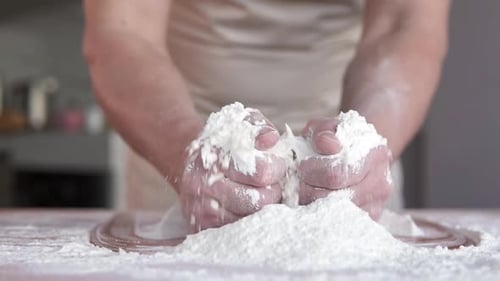 Baker Kneading Dough with Flour in Kitchen