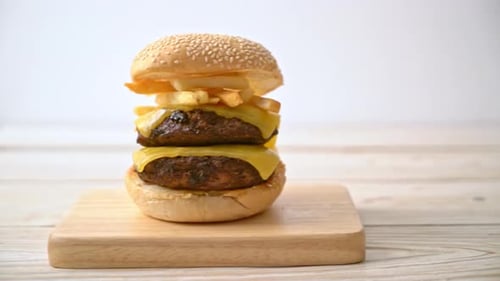 Double Cheeseburger with Fries on a Wooden Board