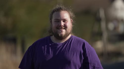 Adult Man Smiling Outside in Mid Shot