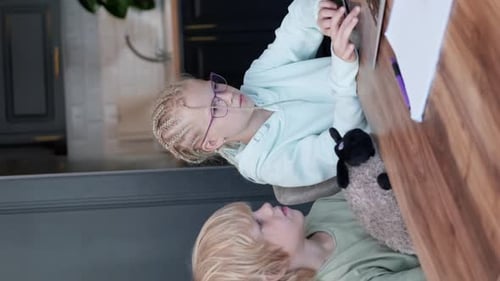 Online School Class Siblings Pupils Boy and Girl Learning Together Remotely Online at Home Looking