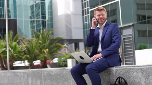 Busy Professional Working Outdoors with Laptop and Phone