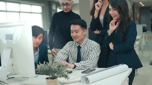 Diverse Business Team Celebrating Victory in Office