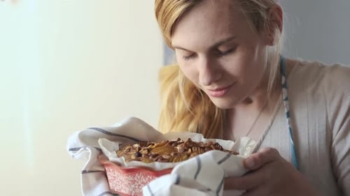 Woman Enjoys Aroma of Freshly Baked Pie
