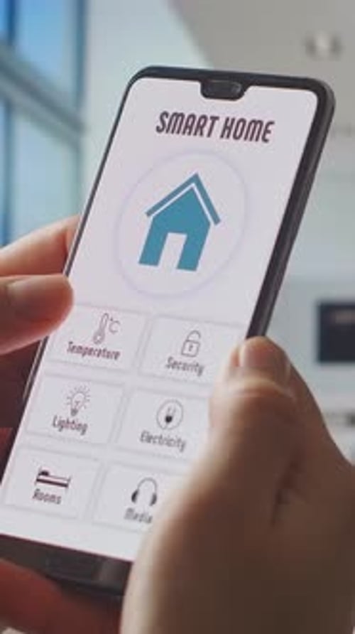 Closeup of Person Using Smartphone Smart Home Control App Interface to Manage Temperature Security