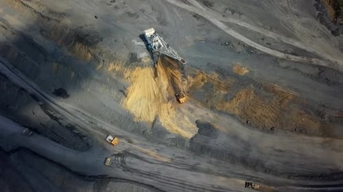 An Aerial View Showcasing Heavy Machinery Working in a Mining Operation From Above Stock Clip