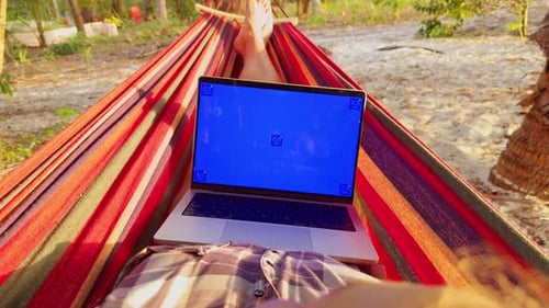 Man Relaxing in Hammock with Laptop with Chroma Key