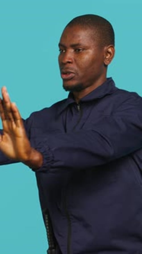 Vertical Video Portrait of Security Agent Doing Crowd Control Securing Assigned Post