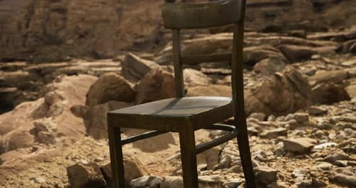 Lonely Wooden Chair on Rocky Terrain Near a Cliff Edge Under Bright Sun