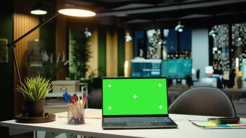 Empty Corporate Workspace with a Green Screen Laptop in a Multinational Company