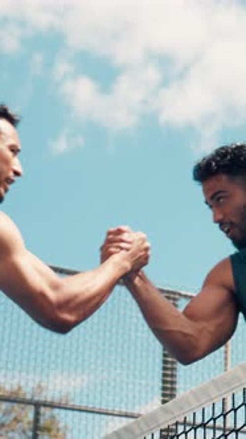 Athletic Men Arm Wrestling by Tennis Court on Sunny Day