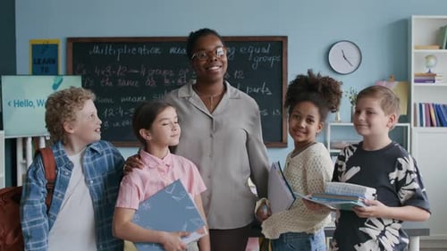 Smiling Teacher and Students in Cheerful Classroom