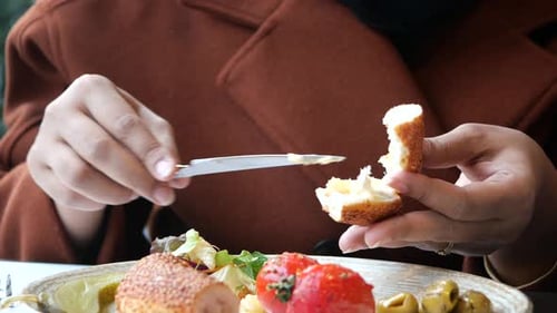 Woman Prepares Unique Bread Meal with Toppings
