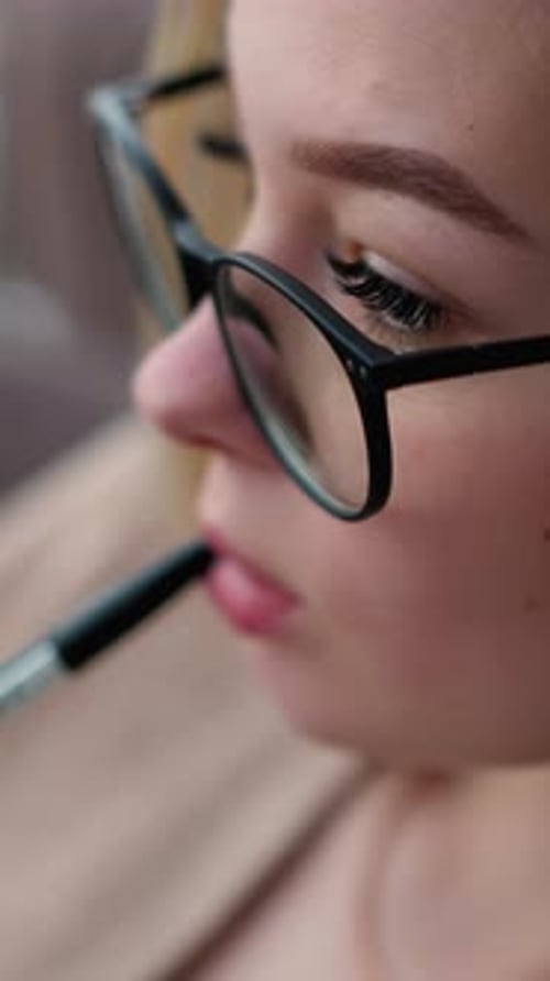 Woman Wearing Glasses Applying Makeup Brush Close-up